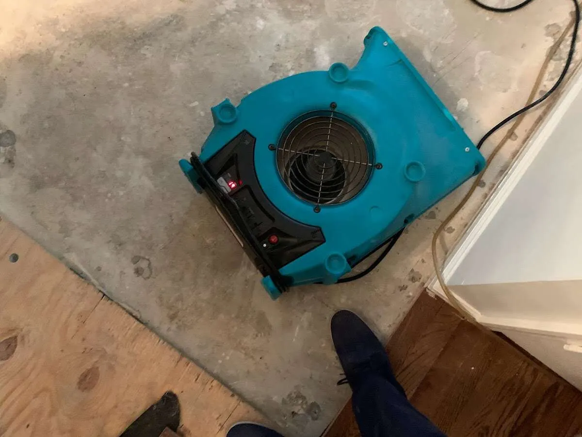 Air mover drying subfloor during Commercial Water Damage Restoration in Ladue